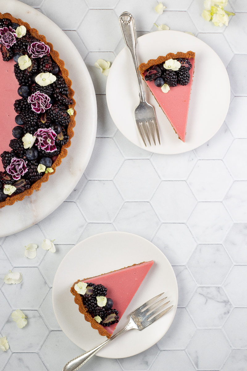 2 slices of Ruby Chocolate Tart on white plates 