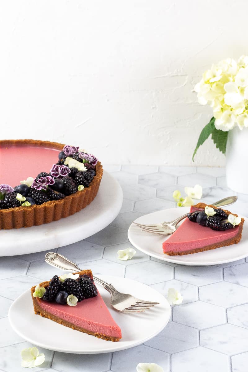 2 slices of Ruby Chocolate Tart on white plates 