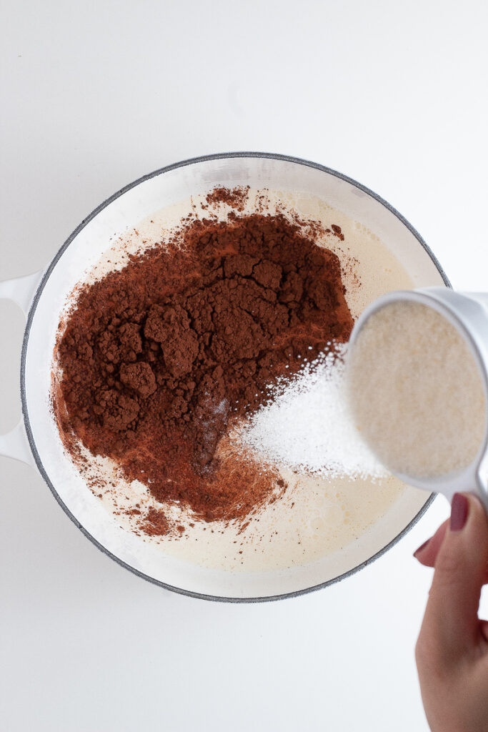 A pot with milk, cream, sugar, cocoa powder and salt