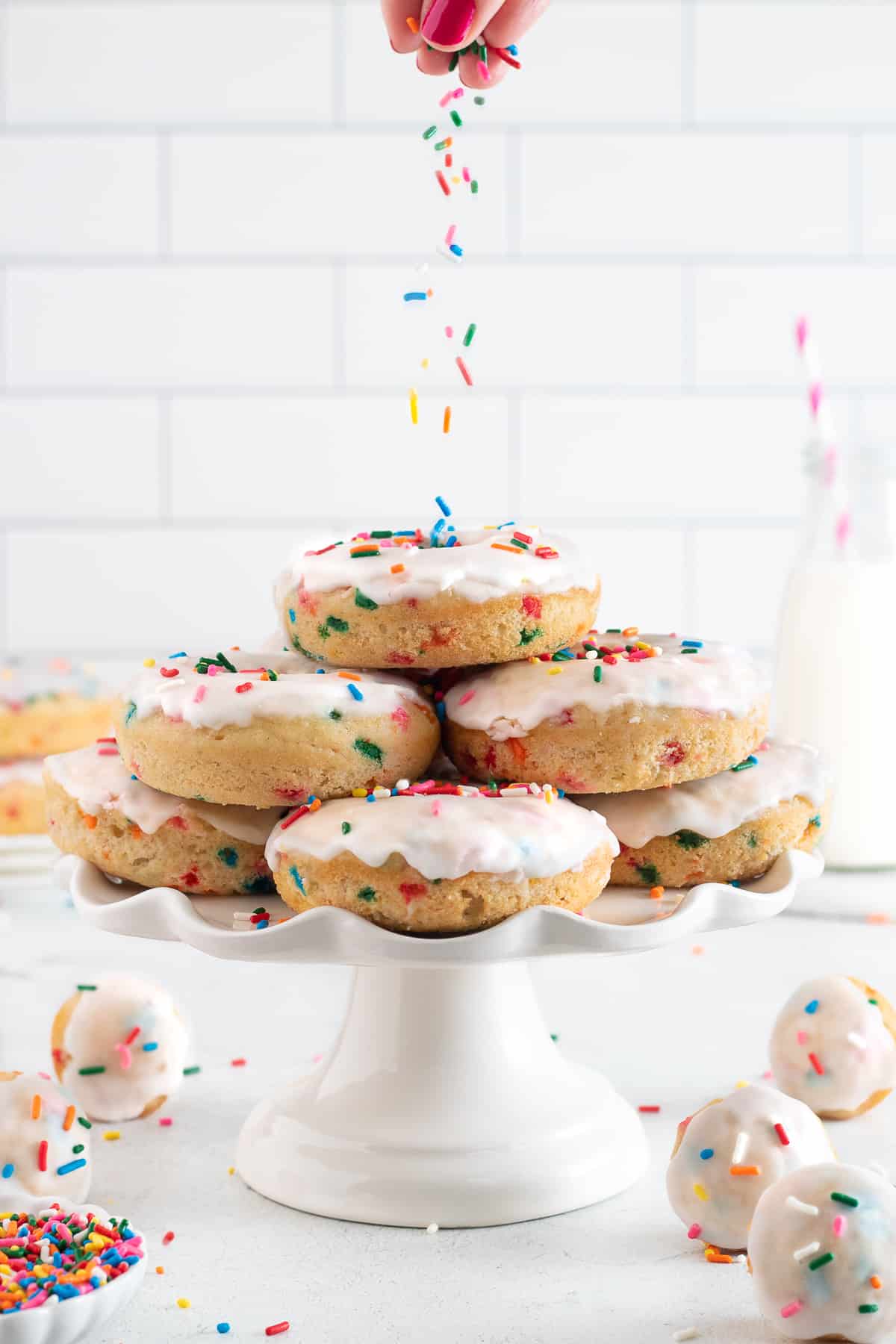 funfetti donuts on a cake stand