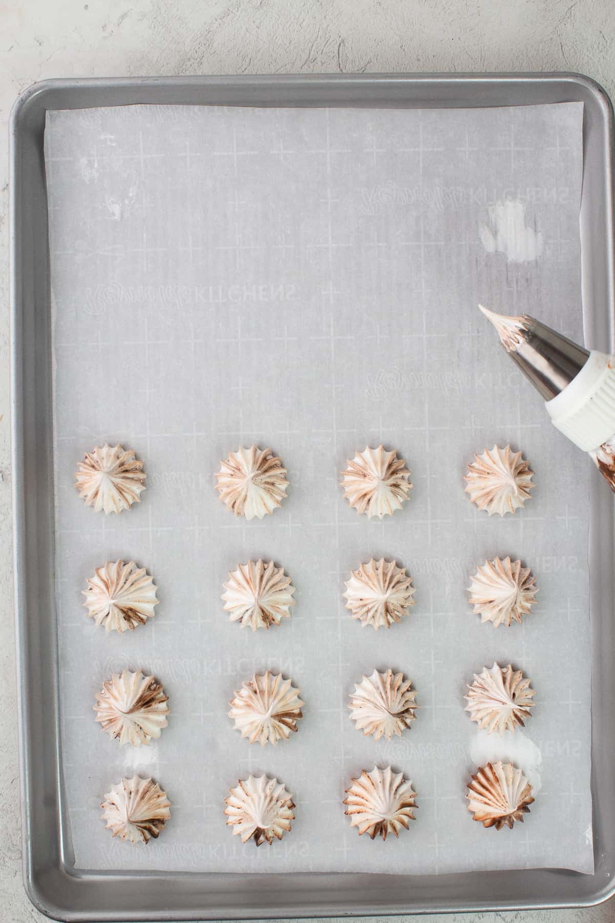 Piped meringue on baking sheet