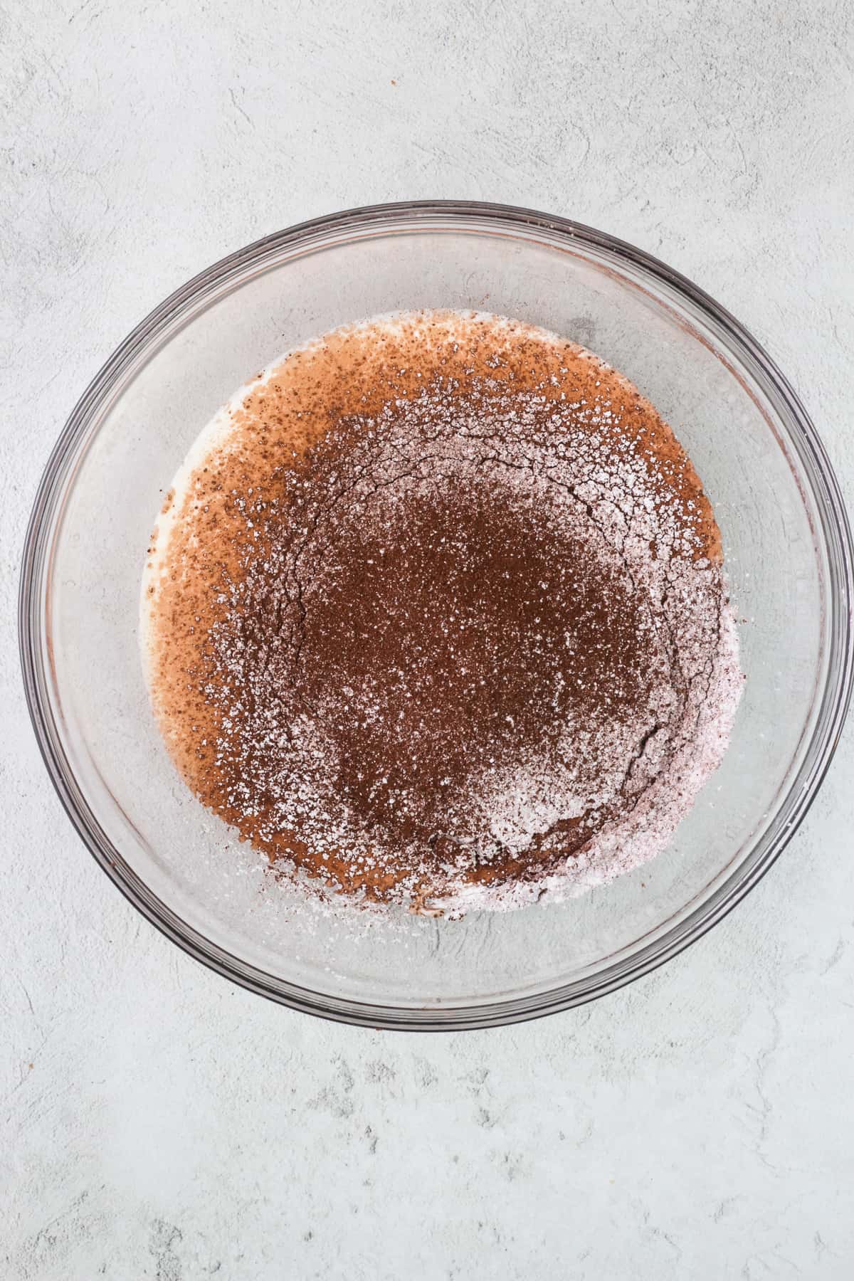 Heavy cream, cocoa powder and powdered sugar in a large glass bowl