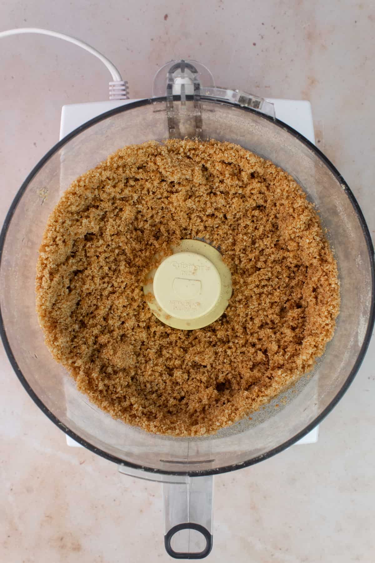 Graham cracker crumbs are in a food processor