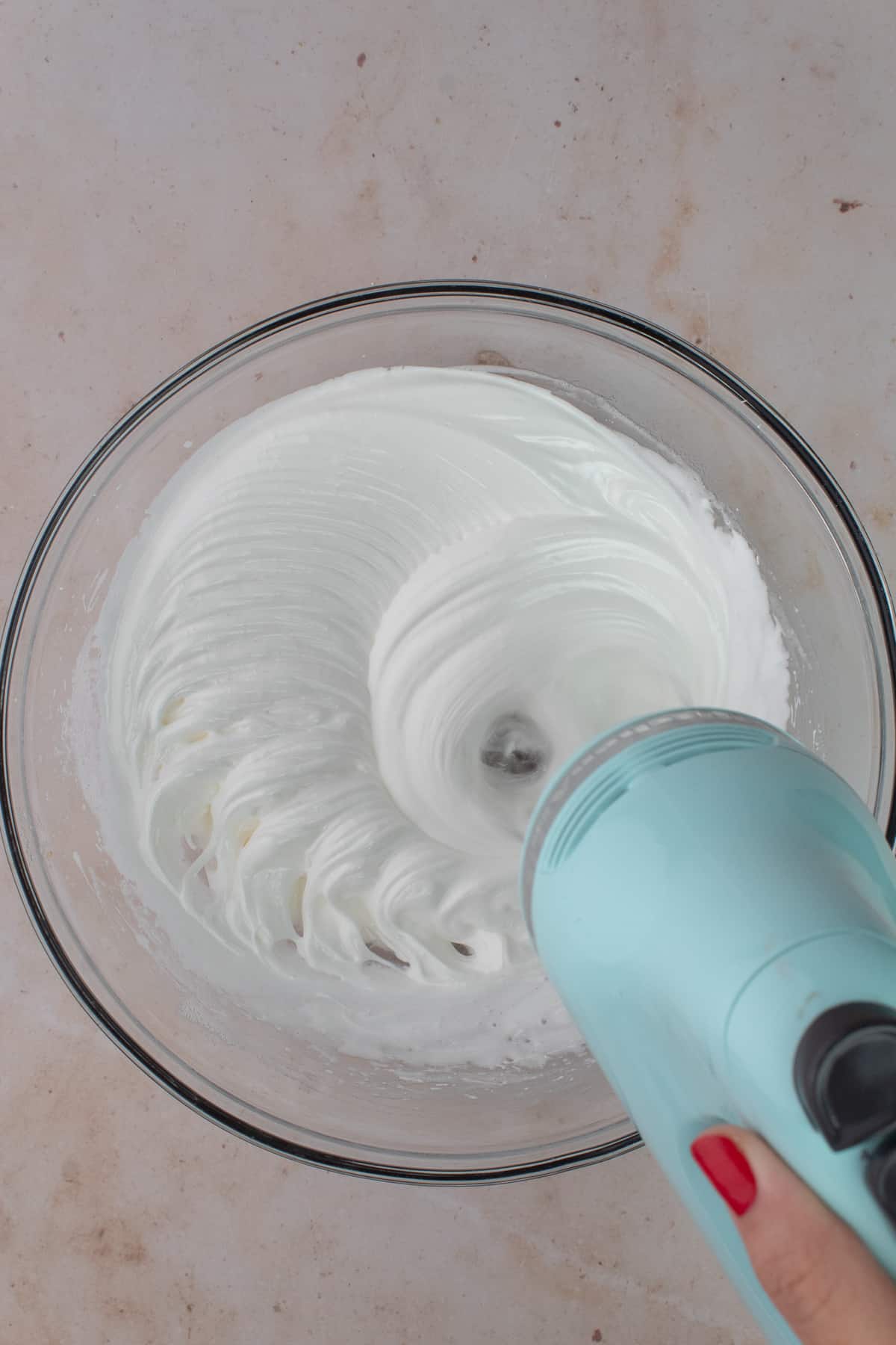 Egg white mixture is whipped to still peaks