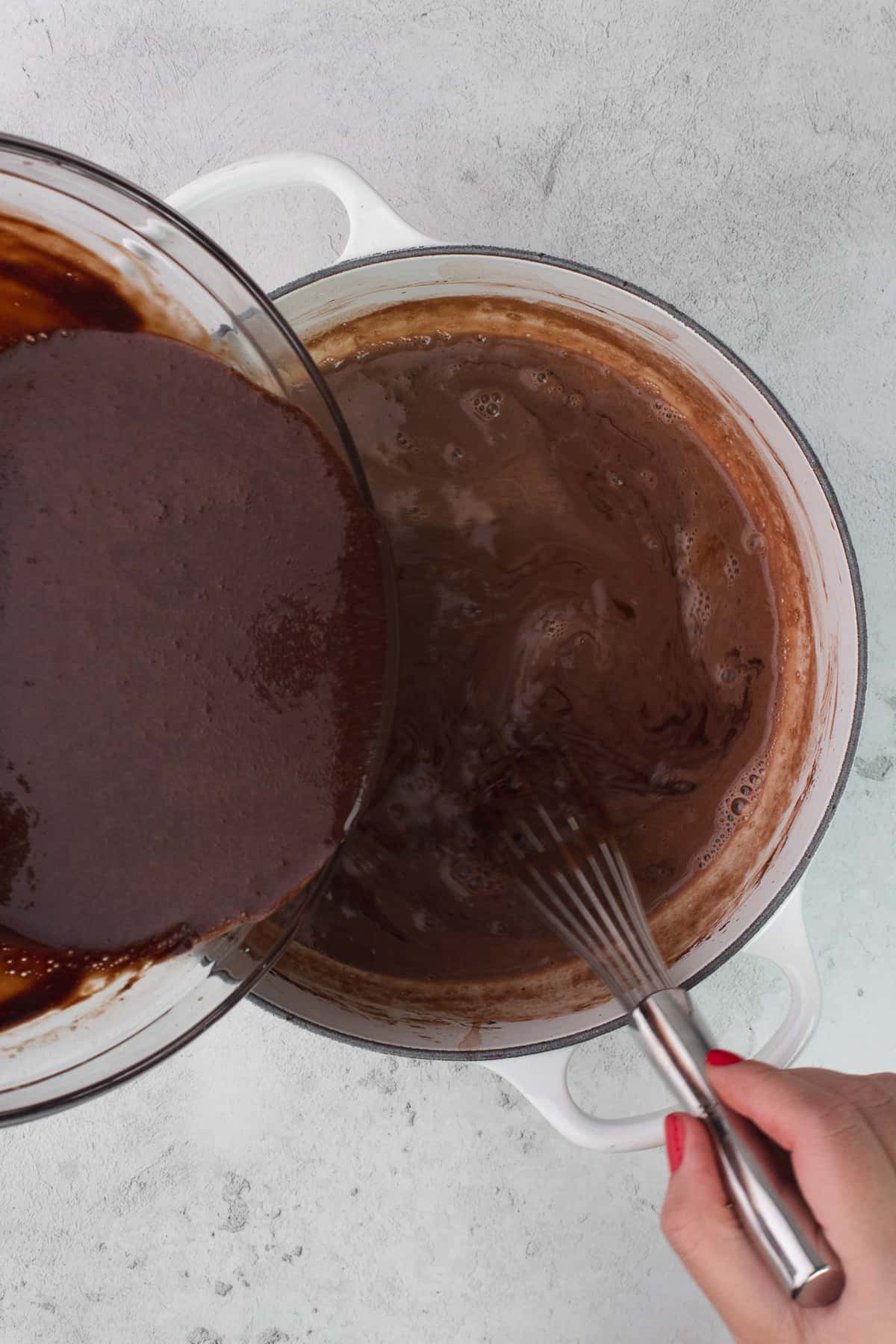 Yolk/chocolate mixture is added back to the pot