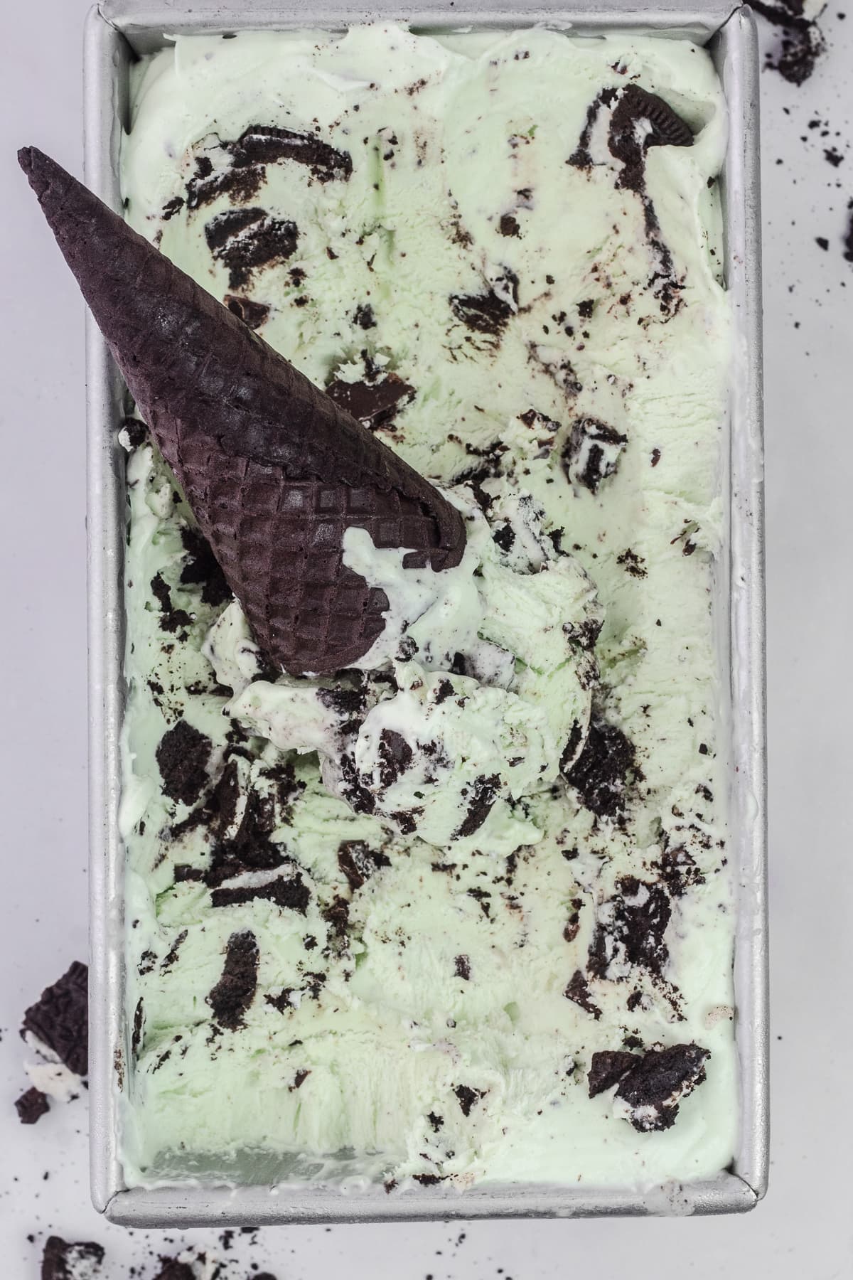 Container of Mint Oreo Ice Cream with chocolate sugar cone