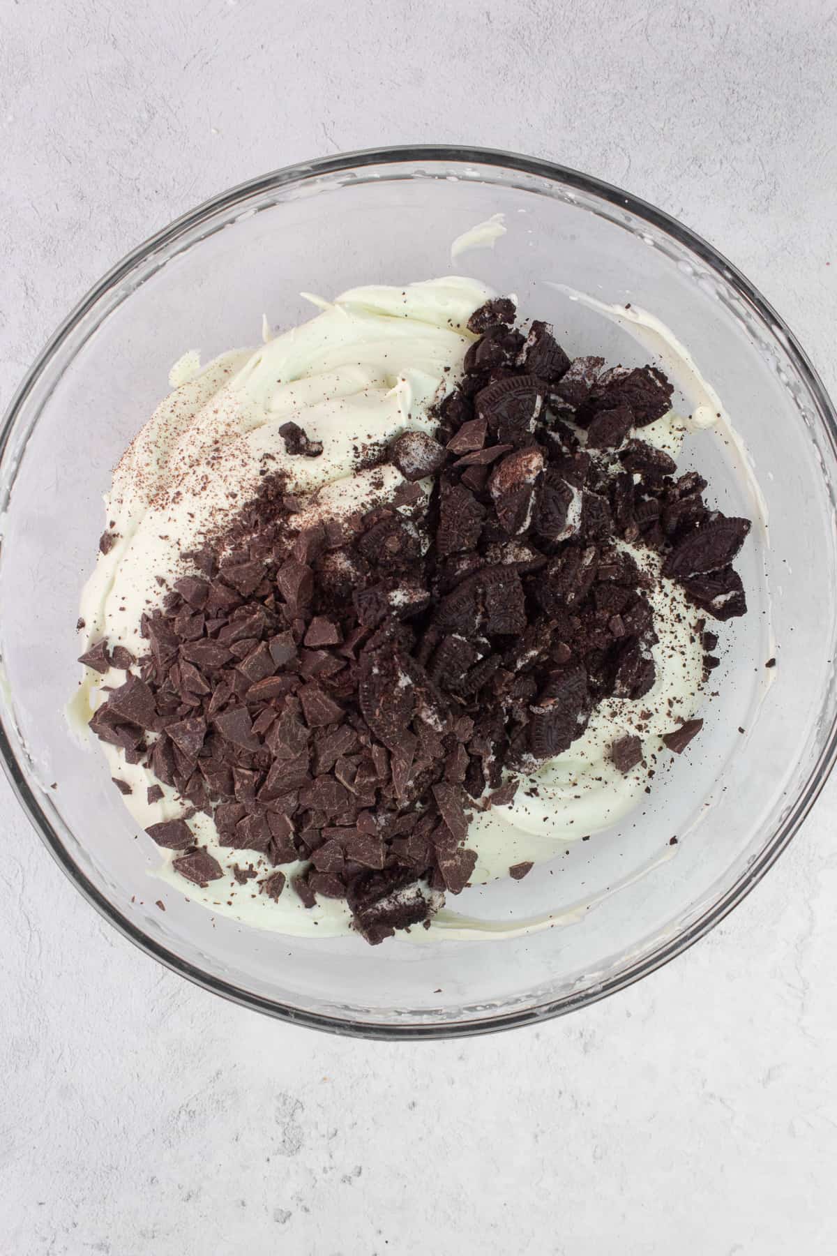 Chocolate chunks and crushed Oreo cookies added to whipped cream