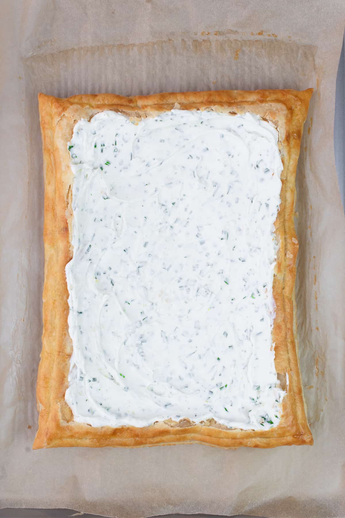 Golden brown puff pastry with a layer of herbed cream cheese