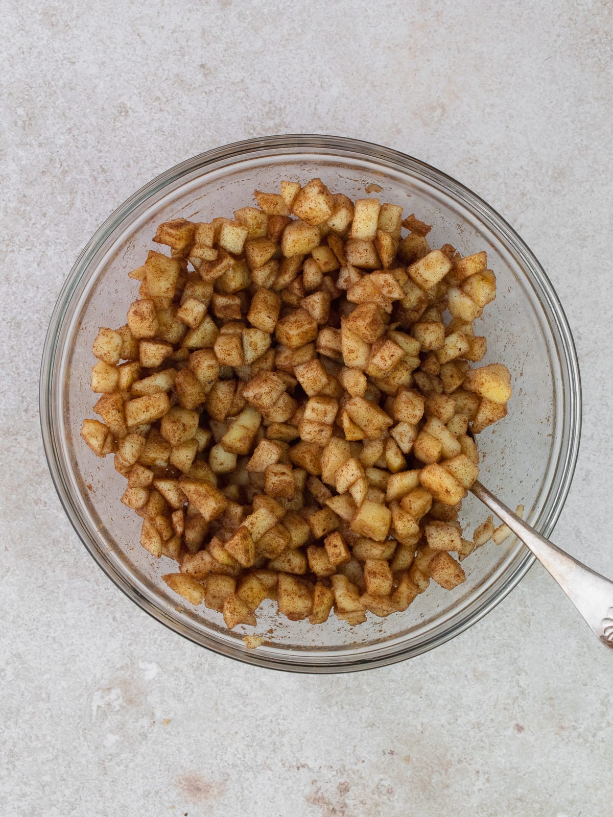 Spiced diced apples in a small glass bowl