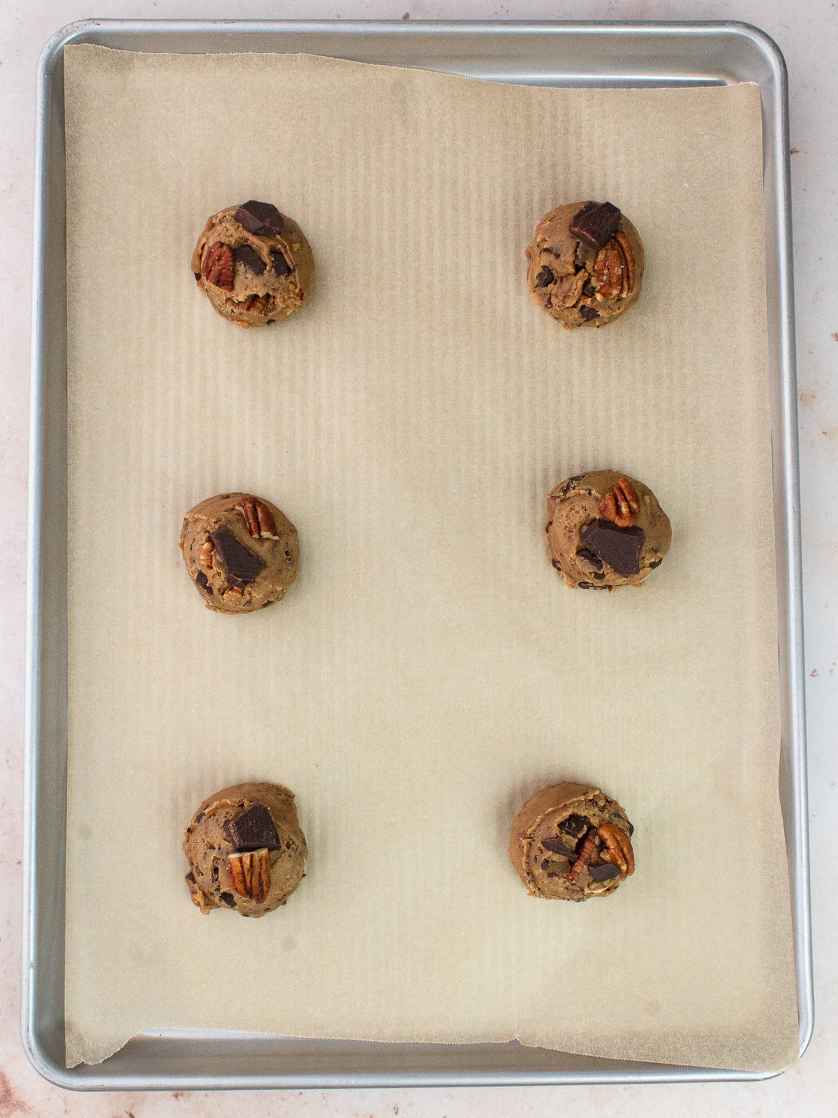 Cookie dough on parchment lined cookie sheet