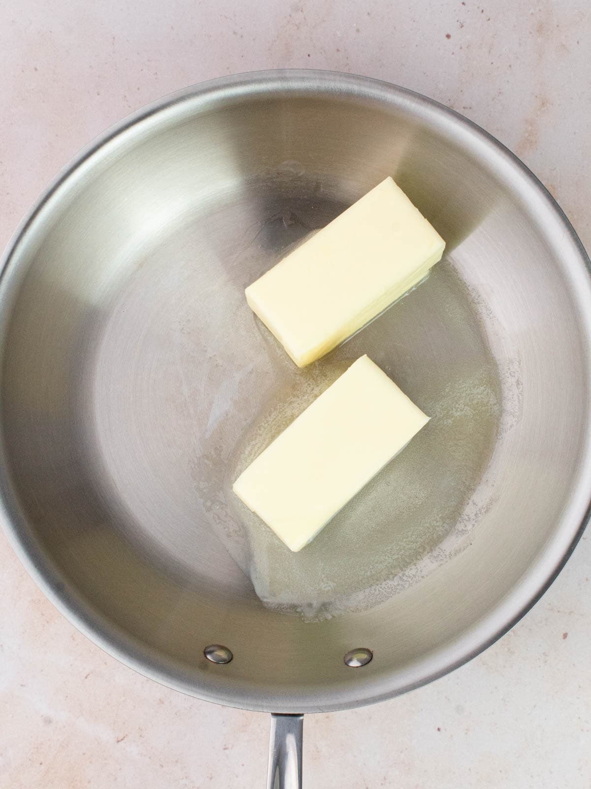 Two sticks of butter in a pan