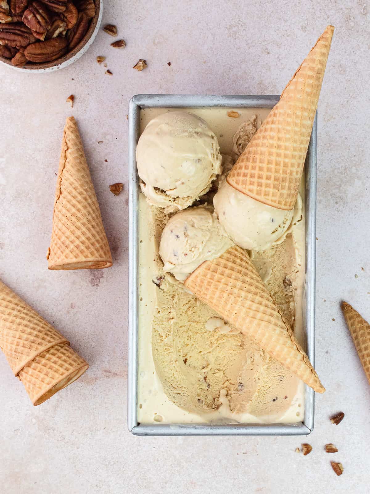 Scoops of brown butter pecan ice cream in loaf pan