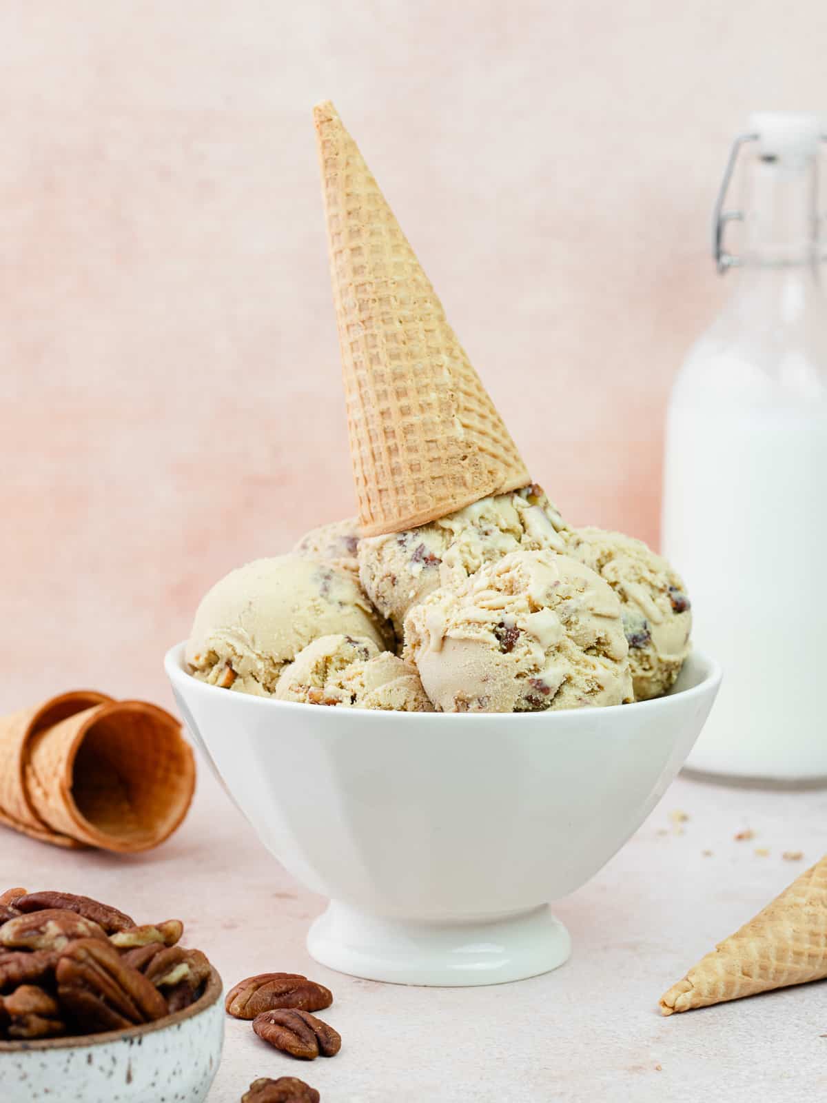 Bowl of brown butter pecan ice cream with cone on top