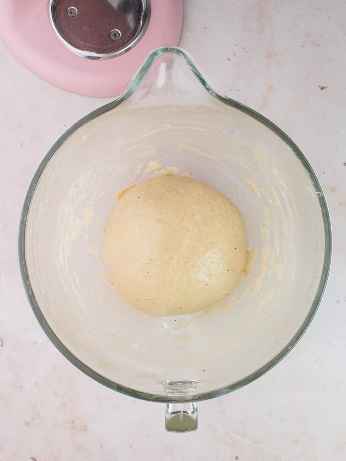 Kneaded dough in an oiled glass bowl