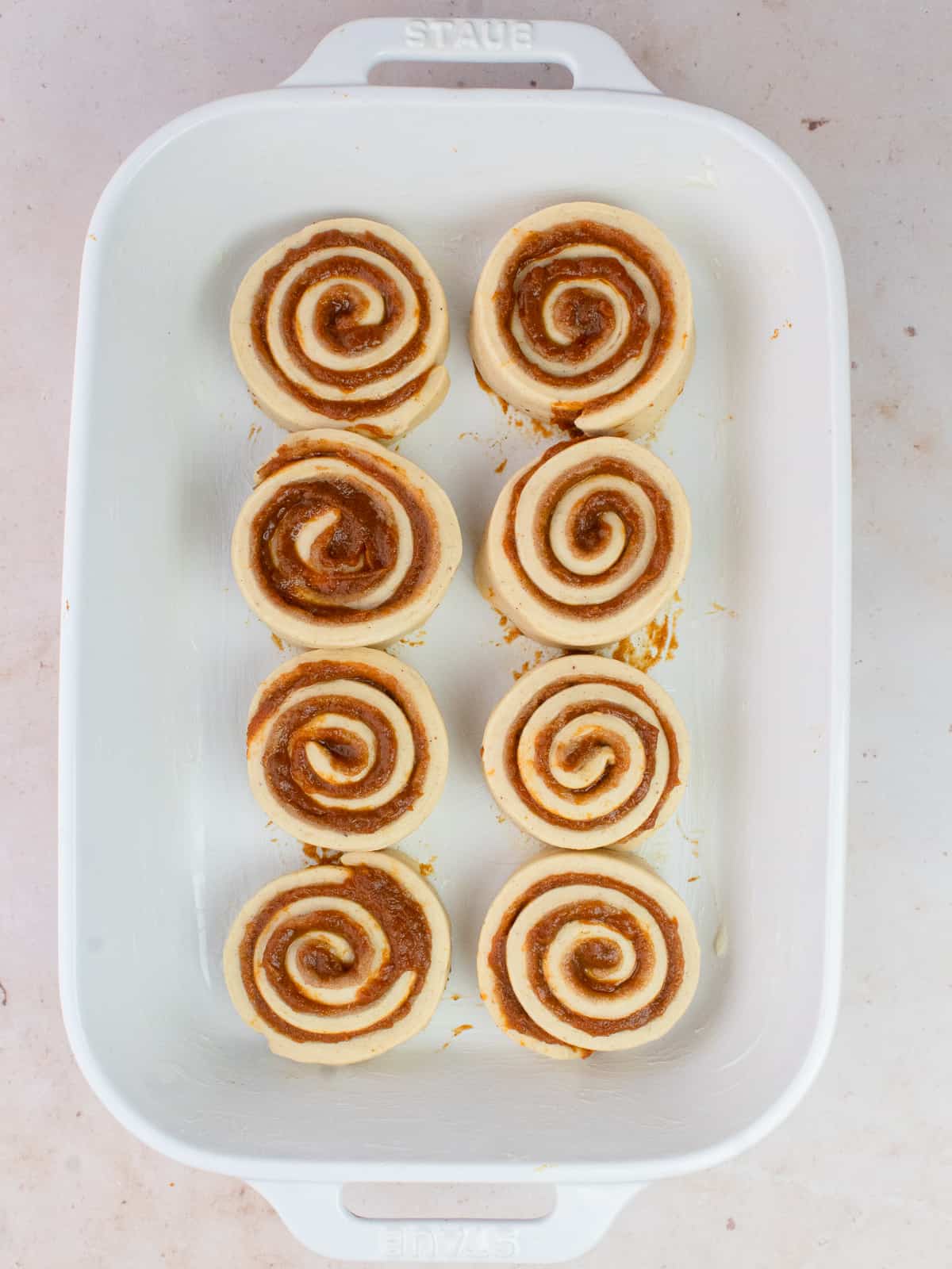 Cinnamon rolls in baking dish before proofing