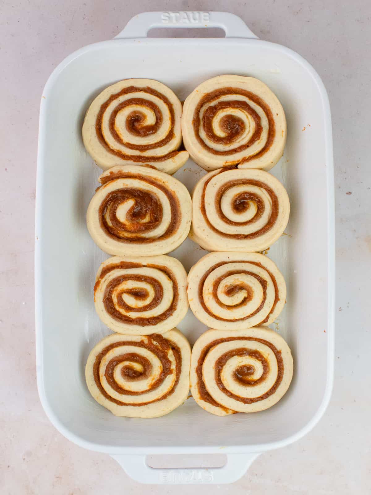 Cinnamon rolls in baking dish after proofing