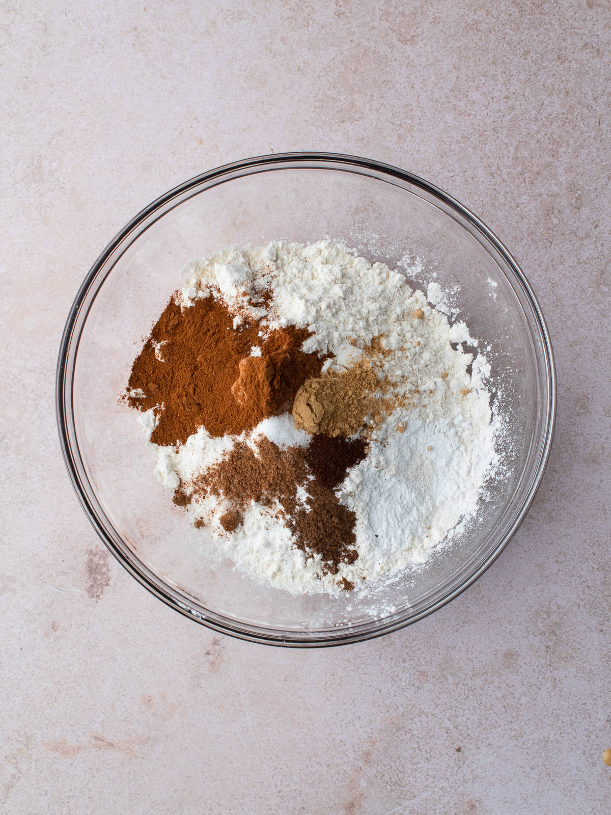 Flour, baking powder, baking soda, salt, cinnamon, ginger, clove, allspice and nutmeg in a medium glass bowl