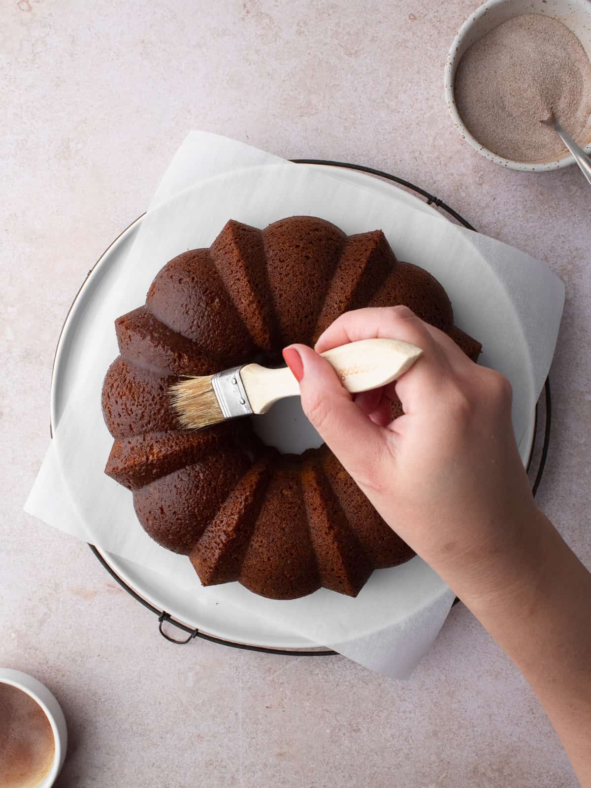 Brushing brown butter onto bundt cake