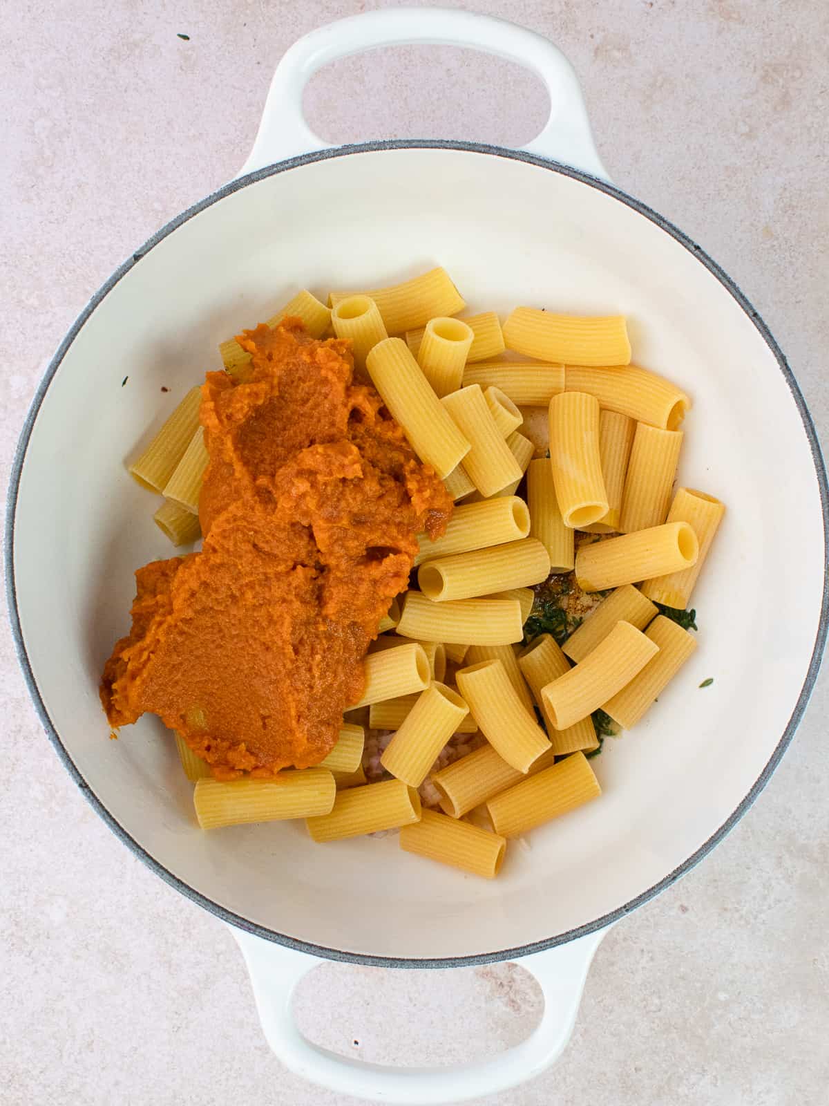 Pumpkin puree and raw rigatoni are added to pot