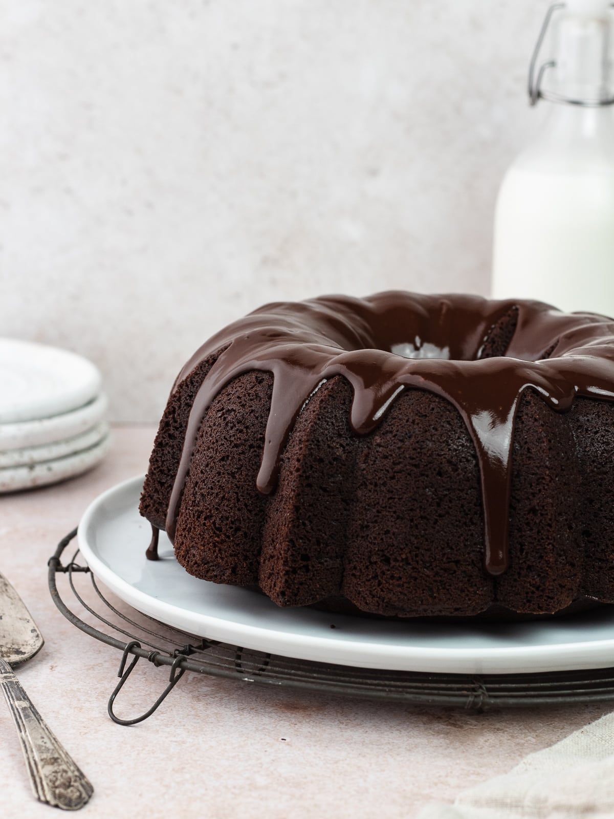 Chocolate olive oil bundt cake with chocolate ganache on a plate