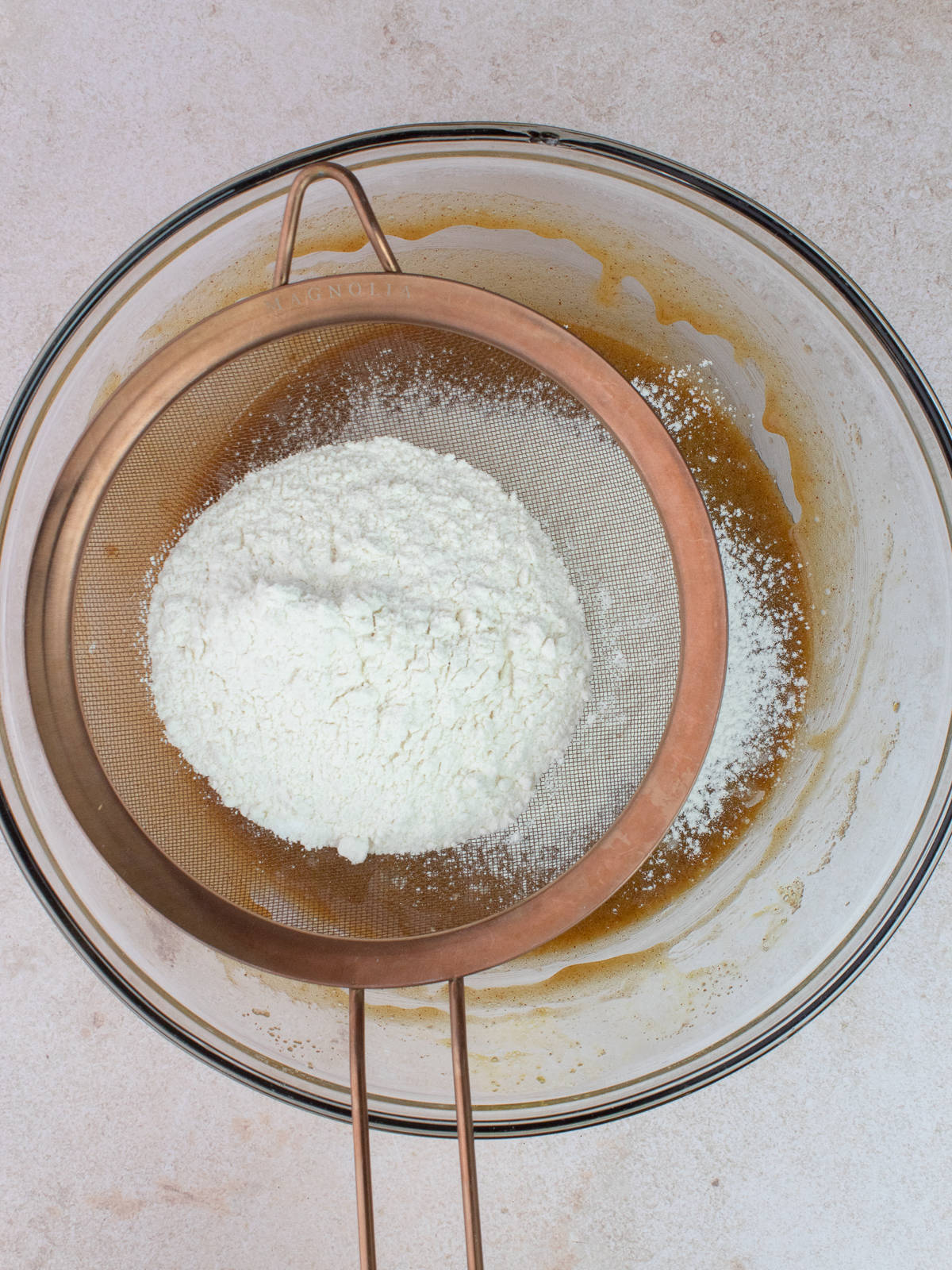 All-purpose flour, baking powder and salt are siftted into wet ingredients.