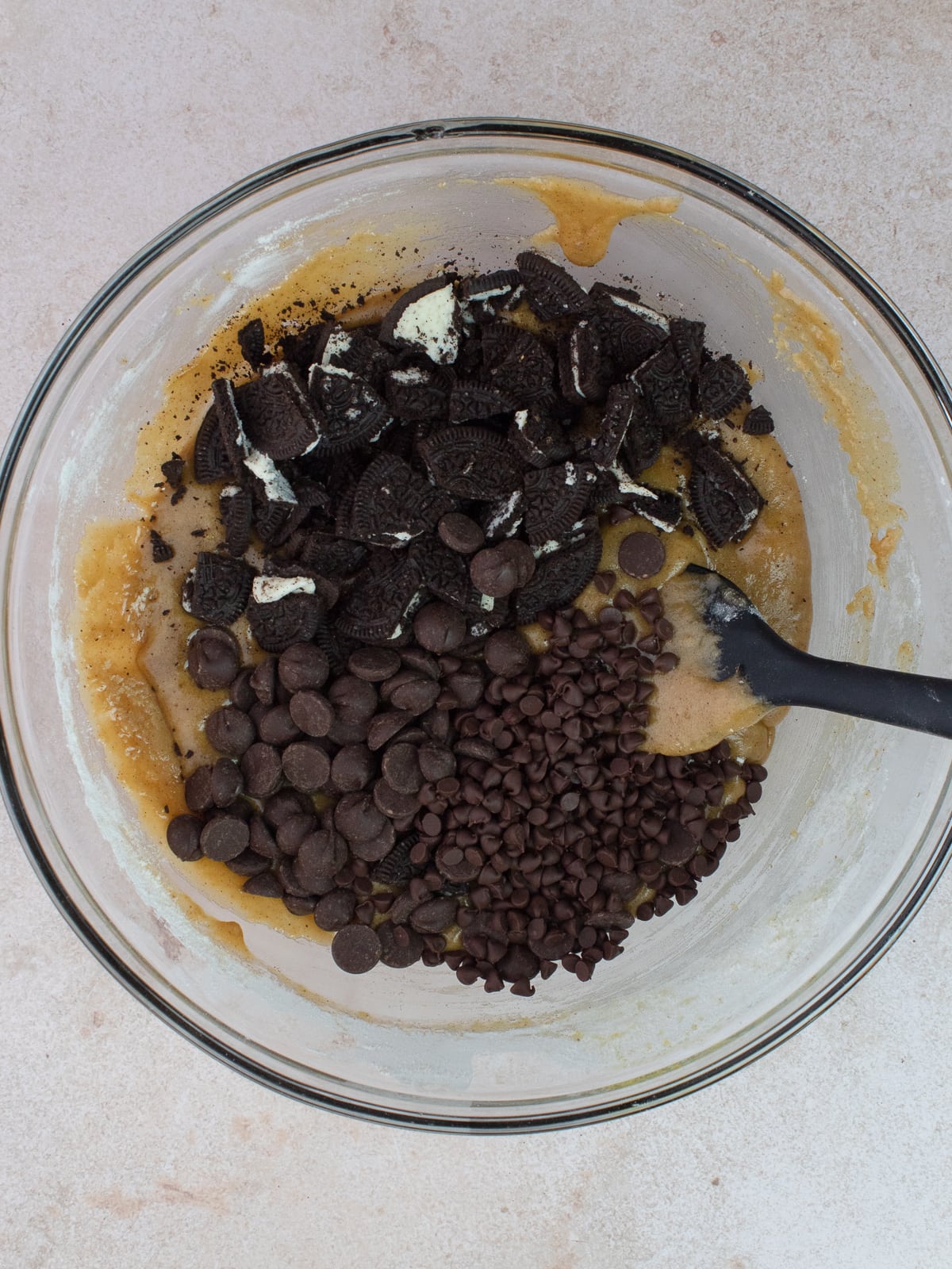 Chopped Oreo cookies, chocolate chips and mini chocolate chip are added to batter