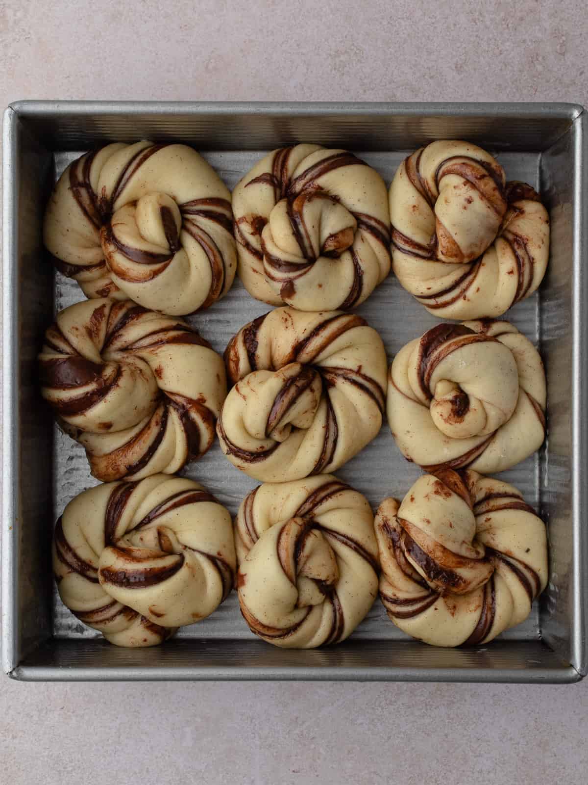 Proofed Nutella knots in square pan