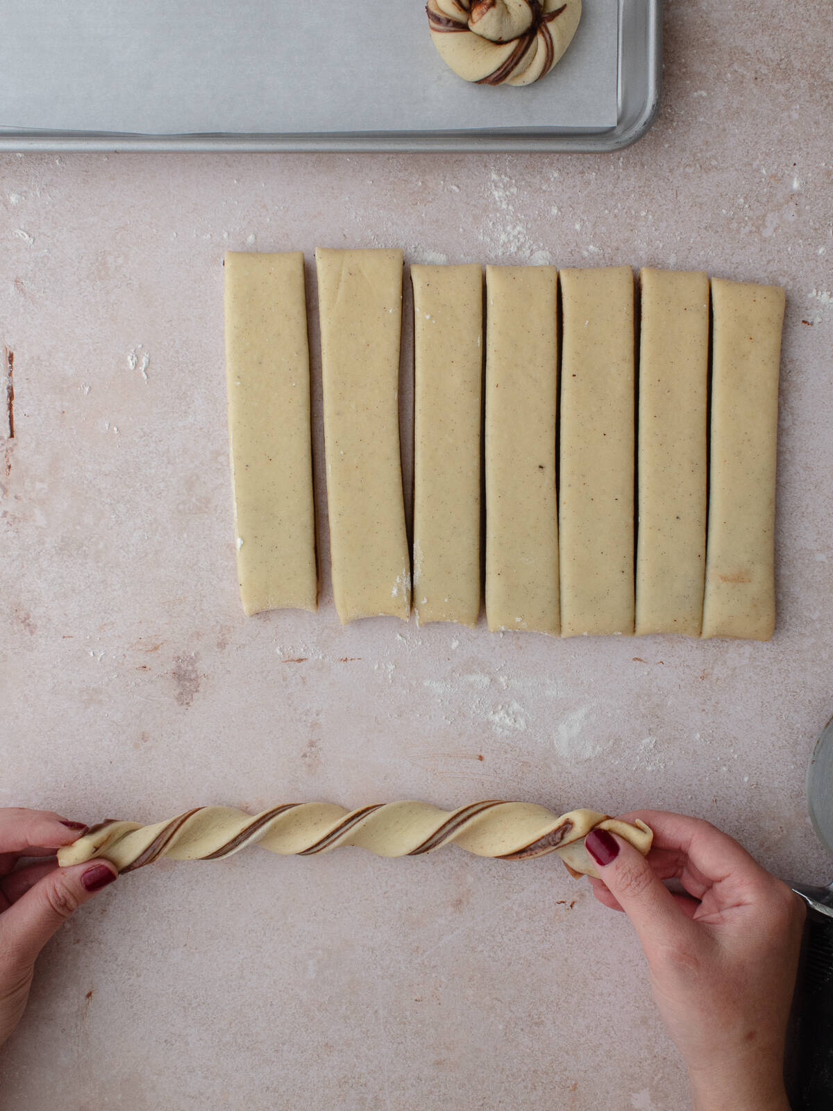 Twisting strips of dough into knots