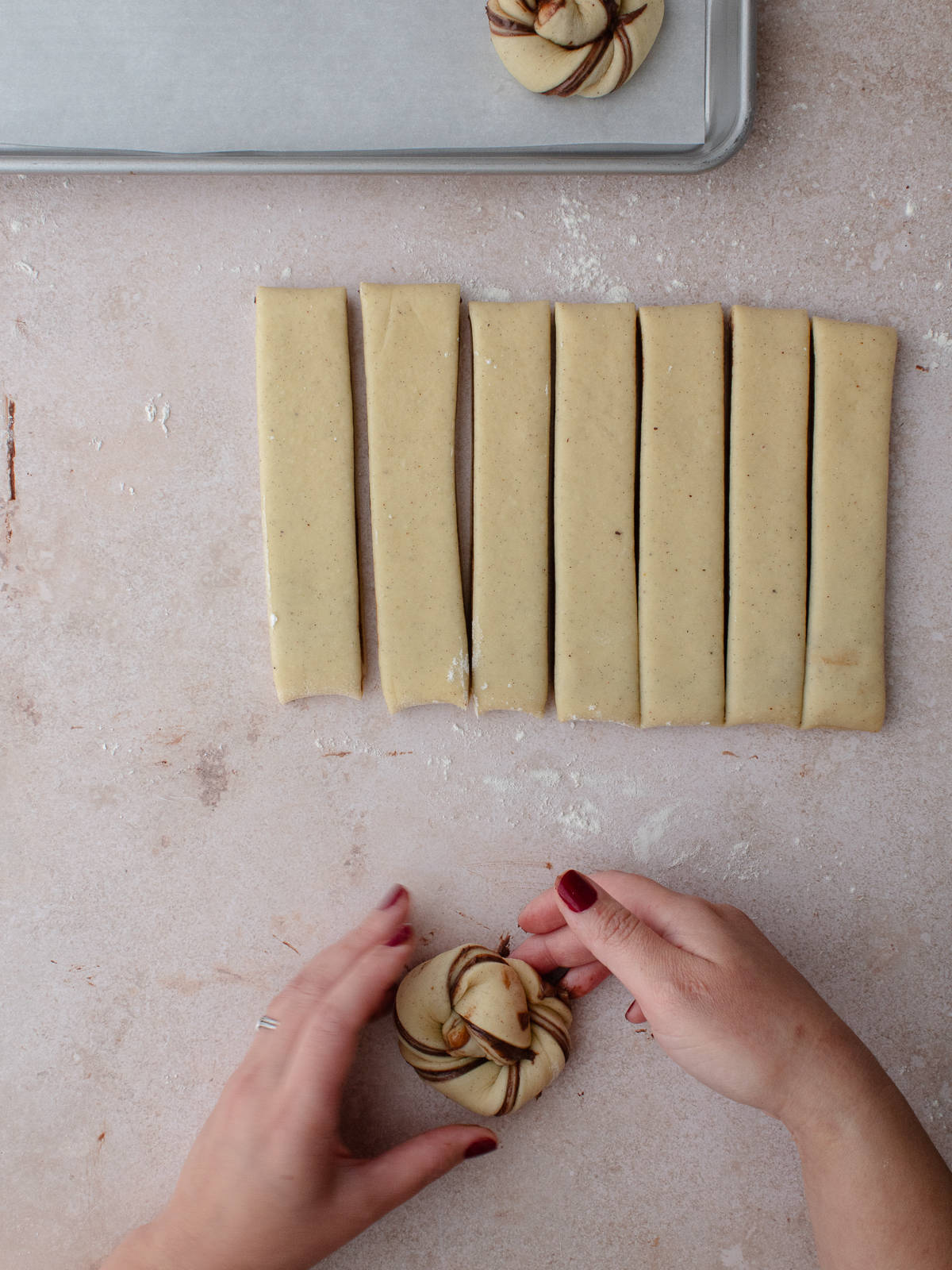 Creating strips of dough into knots