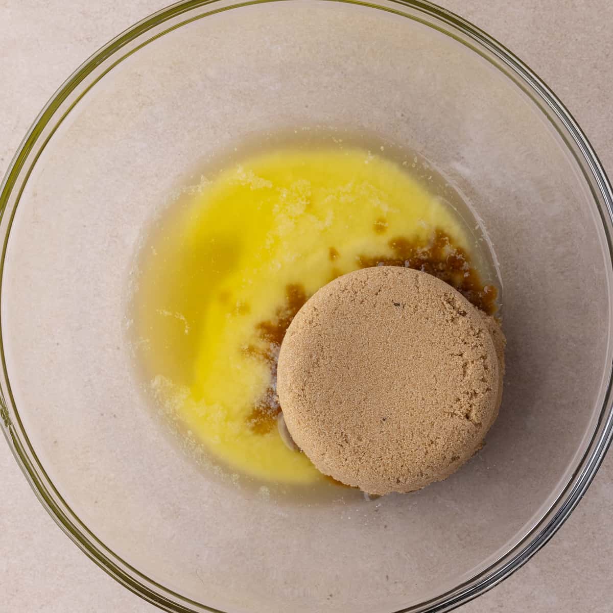 Melted butter and brown sugar in a glass mixing bowl