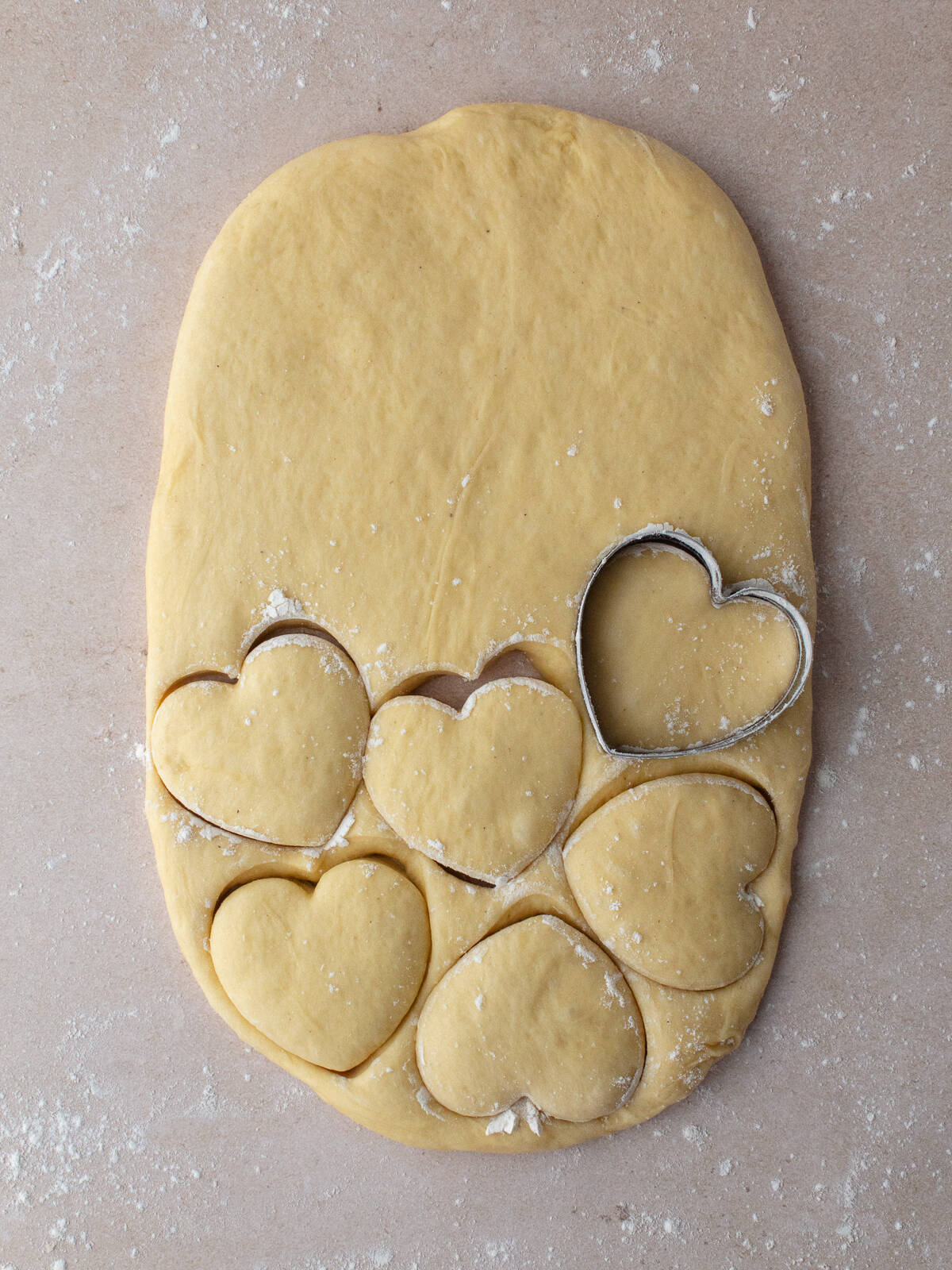 Cutting heart donuts out with heart cookie cutter