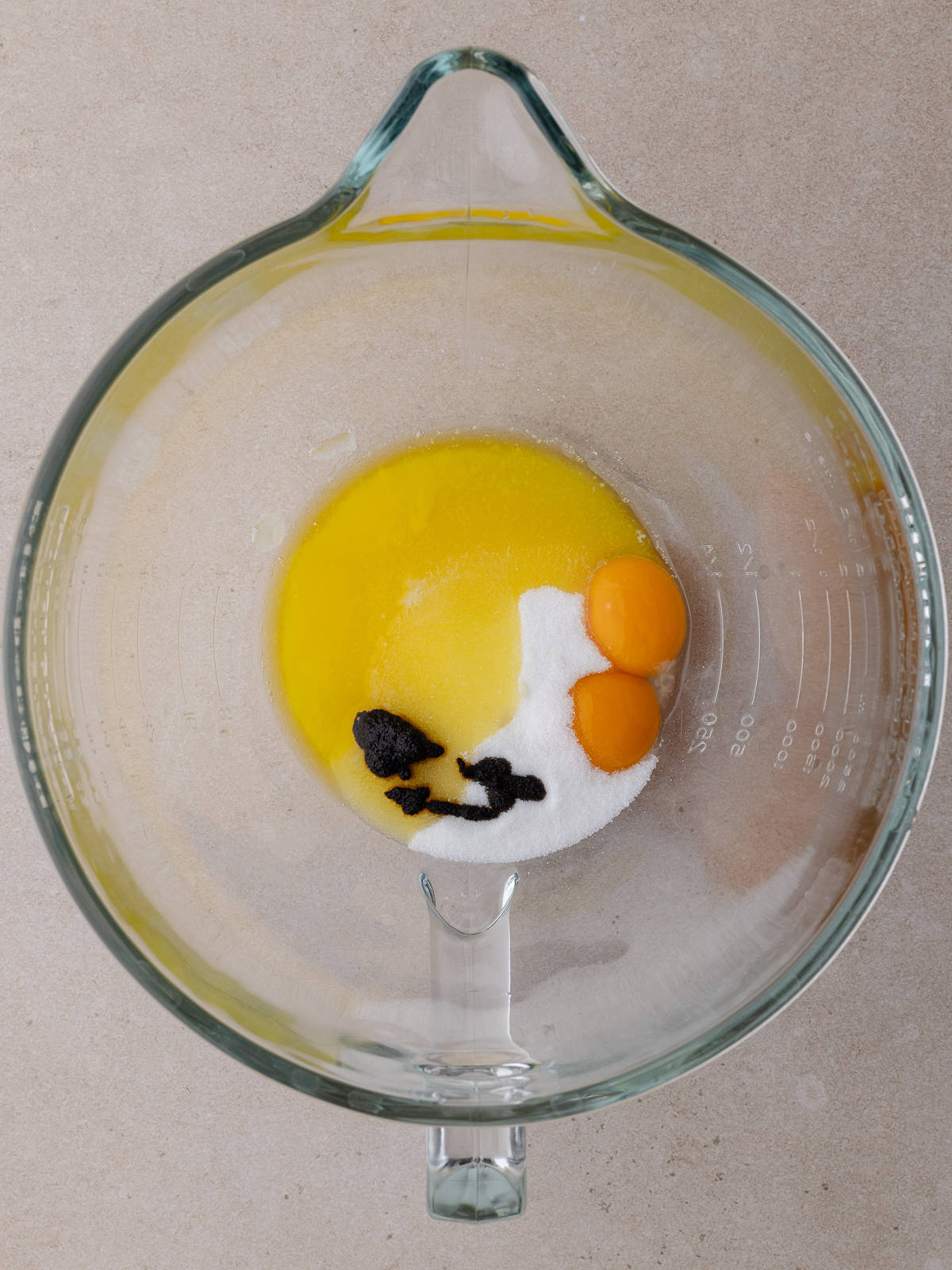 Melted butter, egg yolks, sugar and vanilla are in a large mixing bowl.