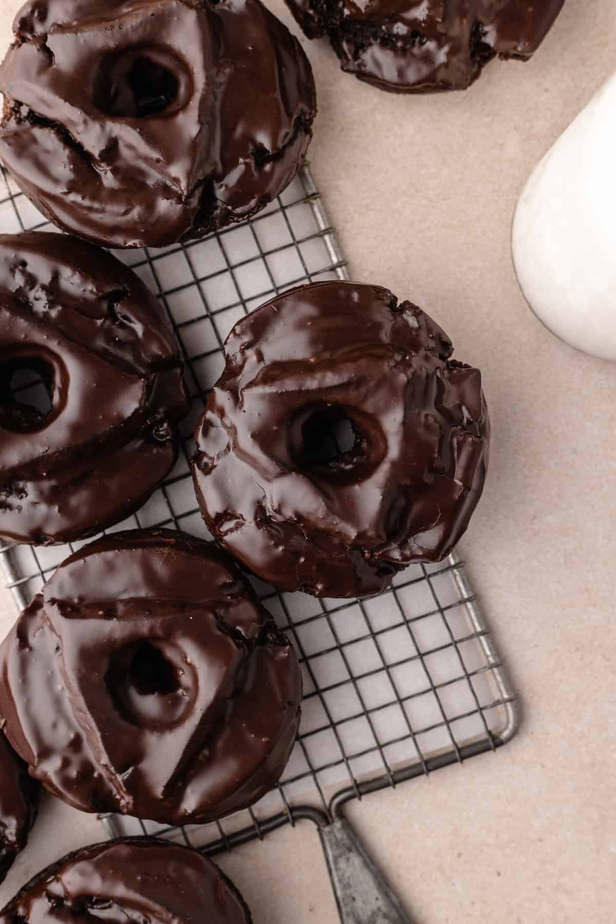 Chocolate old fashioned donuts on wire rack.