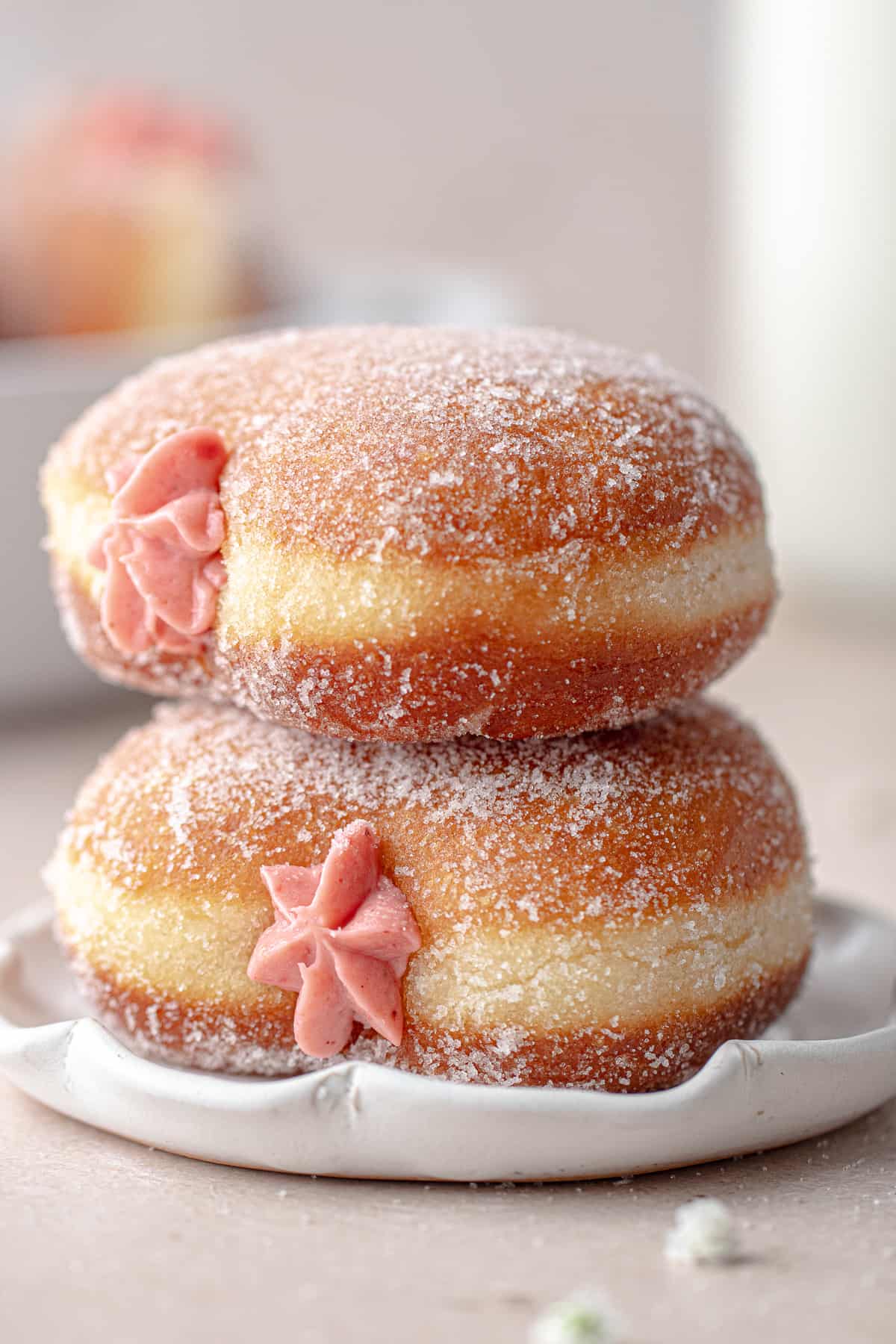 Two donuts stacked on a plate
