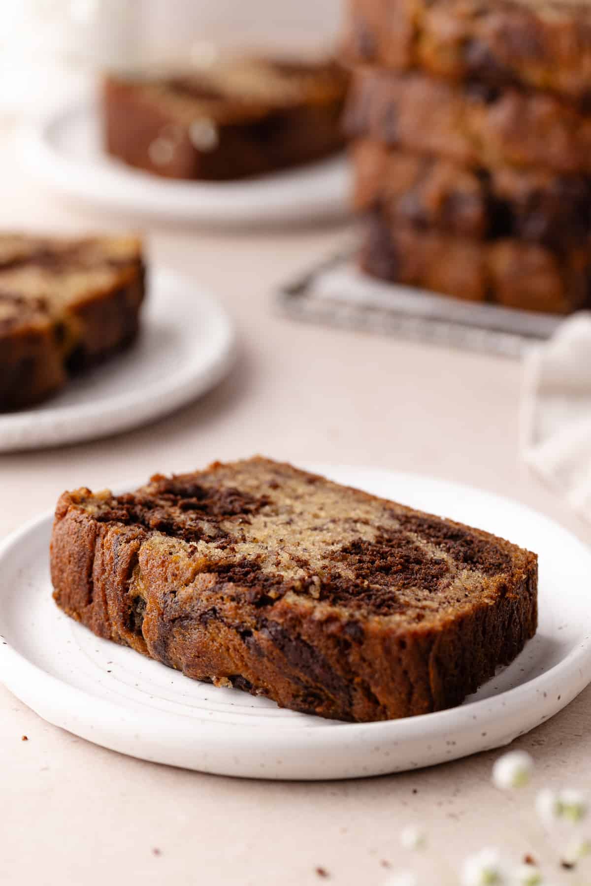 Chocolate marbled banana bread sliced on small plates.