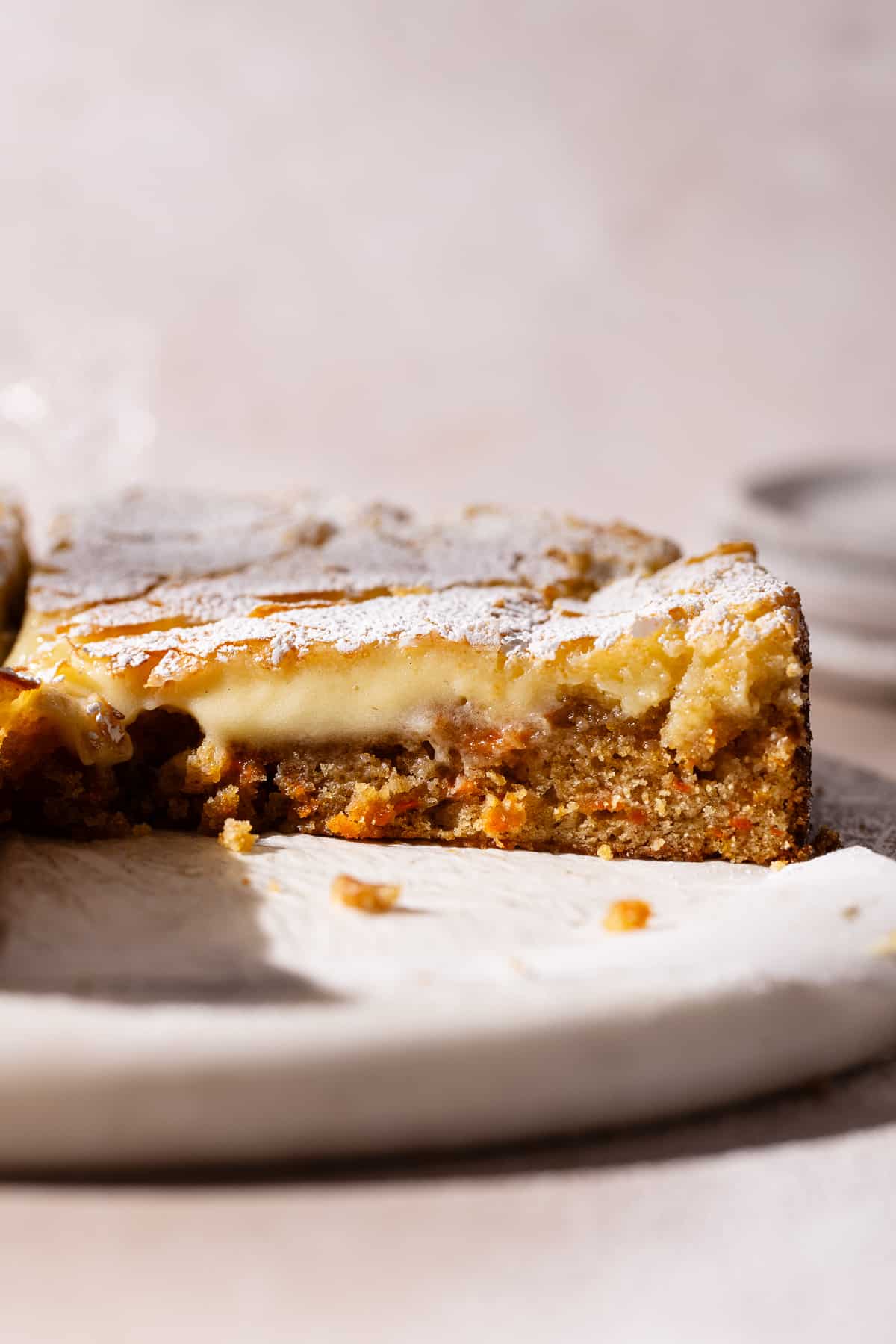 A slice of Gooey Butter Carrot Cake on the side.