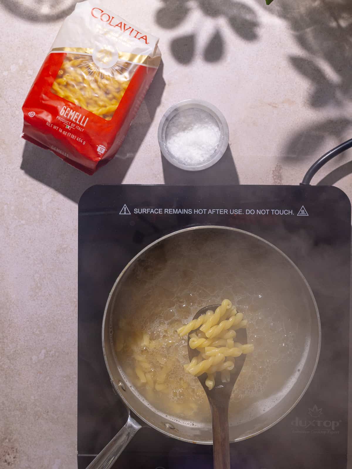 Pasta cooked in a pot of boiling water.
