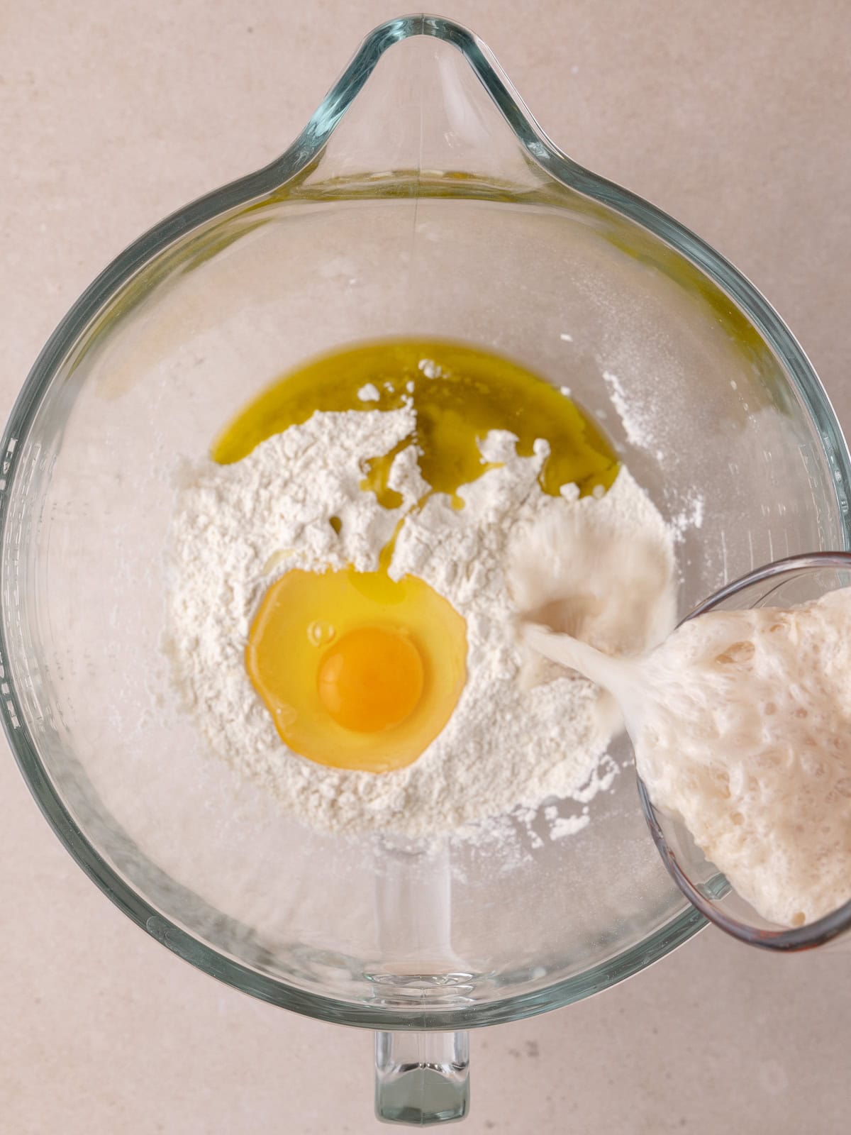 Bread flour, salt, egg, olive oil and yeast mixture in a large bowl.