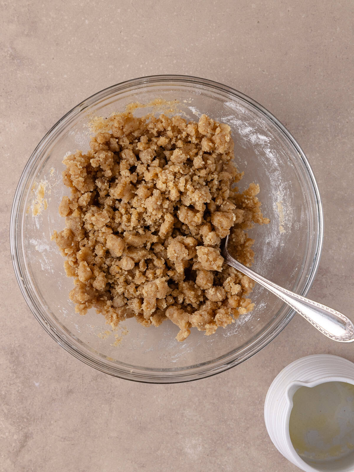 Crumb topping (flour, brown sugar, espresso powder and melted butter) has been mixed together in a small glass bowl.