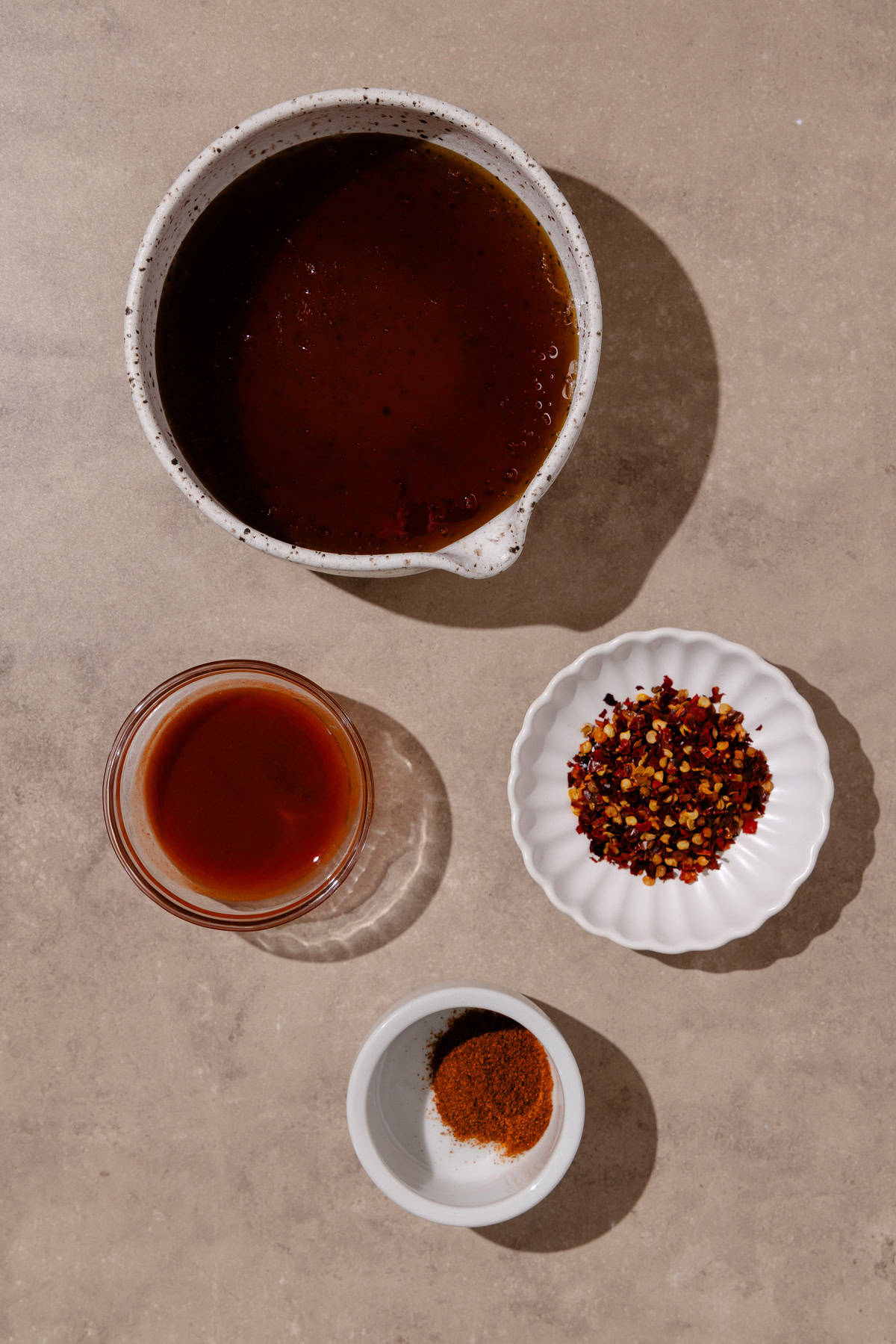 Hot honey ingredients, which include honey, red pepper flakes, cayenne pepper and hot sauce.