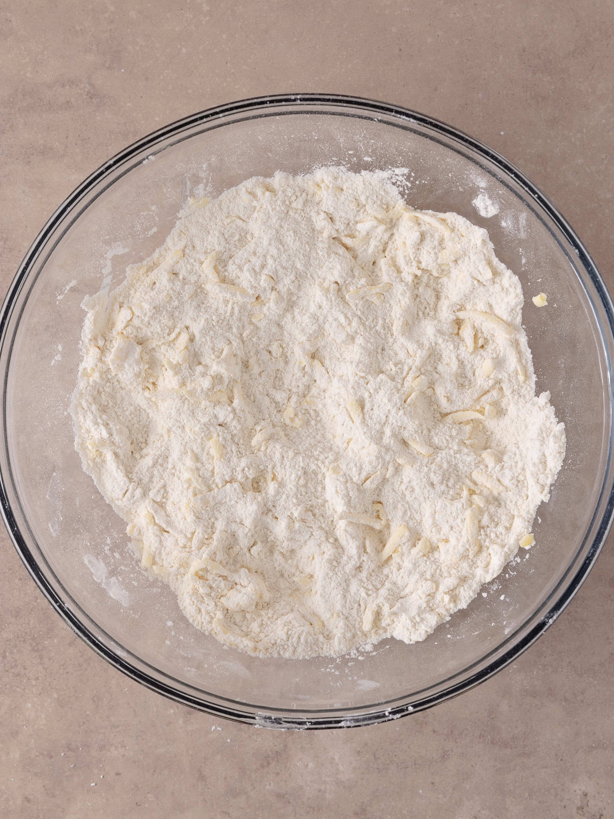 Shredded butter and flour mixture is combined.