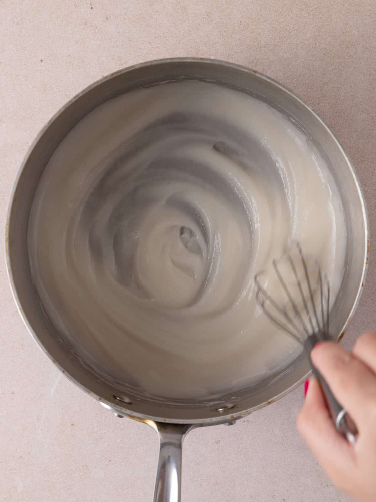 Tangzhong has thickened after whisking and cooking flour and water together in a small saucepan.