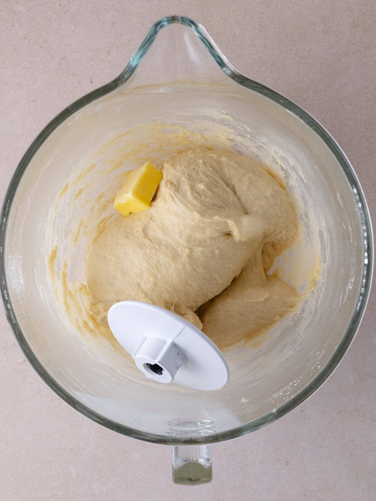 A tablespoon of softened butter is added to the dough after it has been kneaded for 5 minutes.