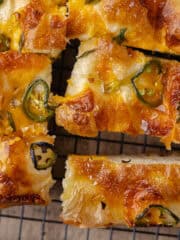Jalapeño cheddar focaccia on a black cooling rack featured photo.