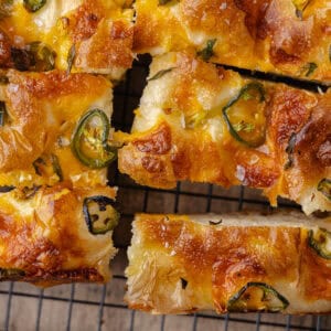 Jalapeño cheddar focaccia on a black cooling rack featured photo.