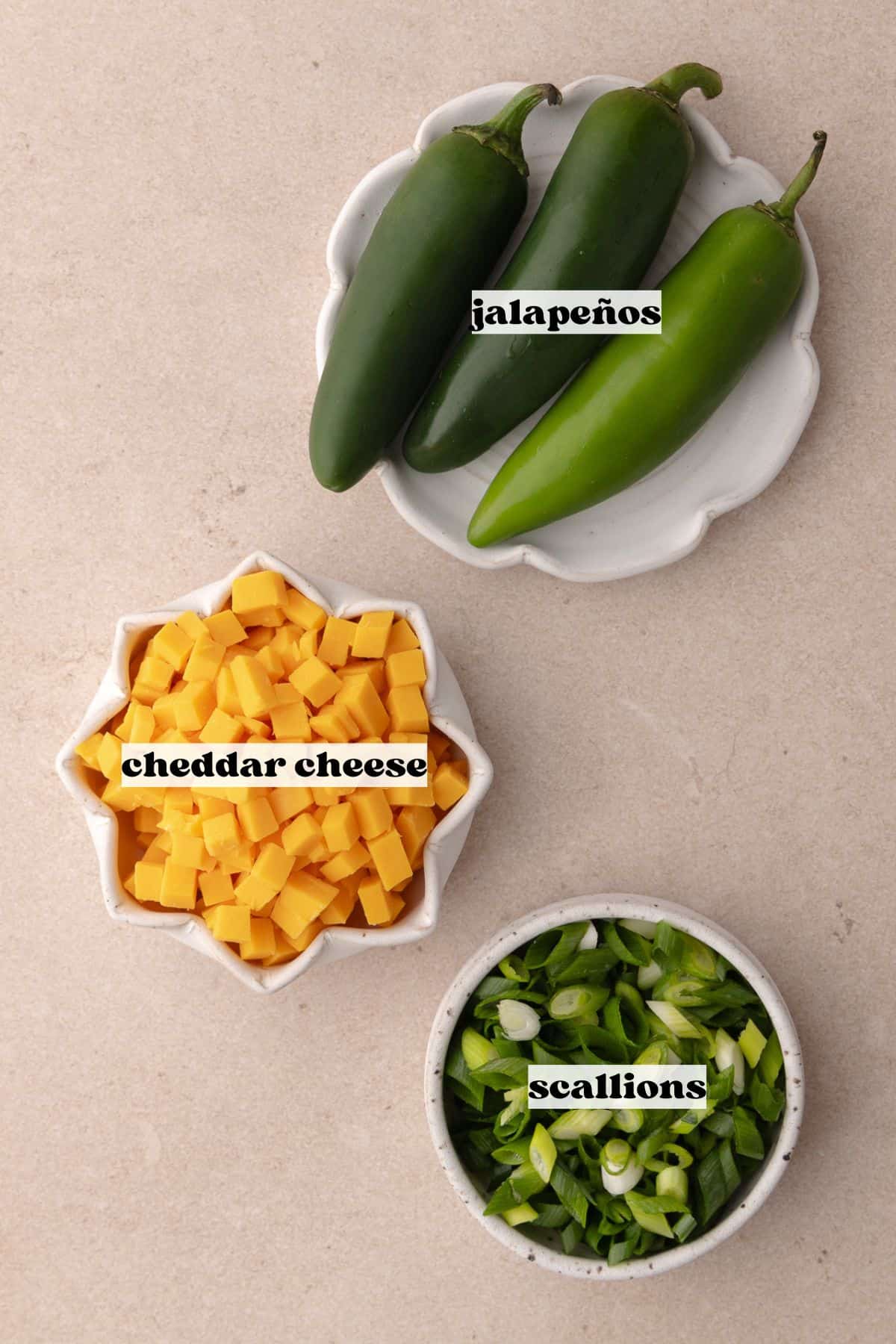 Toppings for the jalapeno cheddar focaccia bread which includes, fresh jalapenos, cheddar cheese and green scallions.