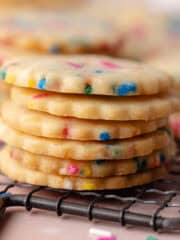 A stack of funfetti shortbread cookies on a wire rack feature photo.