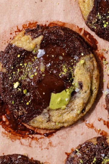 Pistachio chocolate chip cookies stuffed with pistachio cream and topped with flaky sea salt featured photo.