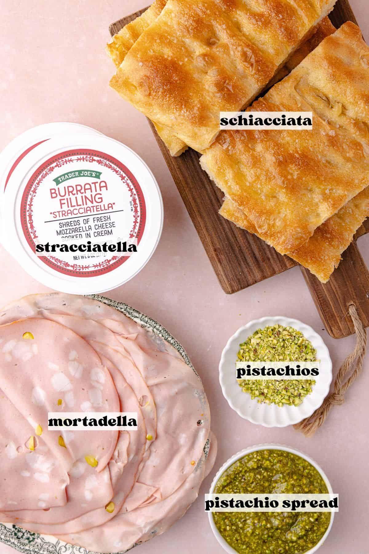 Mortadella sandwich ingredients which include, pistachio mortadella, savory pistachio cream, stracciatella cheese, crushed pistachios, and homemade schiacciata bread.