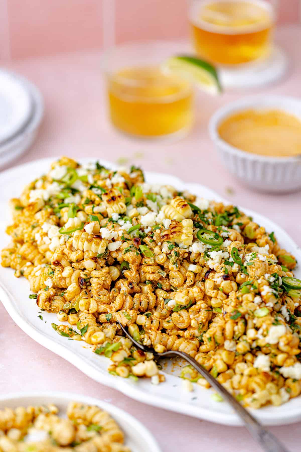 Elote pasta salad with charred corn, gemelli pasta, crumbled cotija cheese, chopped scallions, cilantro and chopped jalapeño tossed with creamy smokey Greek yogurt dressing.